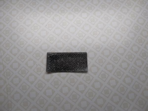 A rectangular one-layer calibration print. Neither gaps between extruded lines, nor ridges are visible.