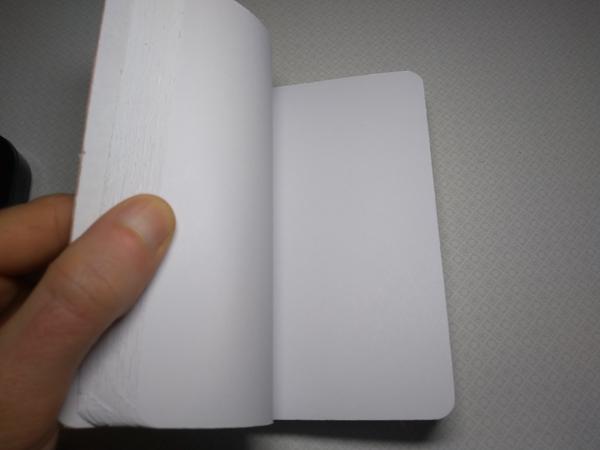 An open notebook with blank pages. The sides of the paper are visibly rough.