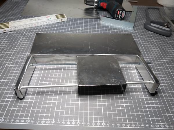 A flimsy construction of bent aluminium sheet, resembling a linear axis.
