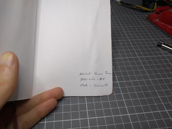 The notebook, showing the following signature on the inside of the cover: Notebook · Hanno Braun · 2022-W34 · #6 · Made in Odenwald