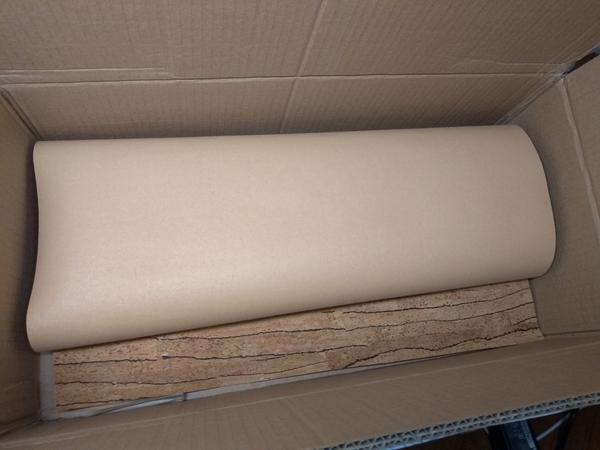 A big sheet of cork leather, in the cardboard box it was shipped in.