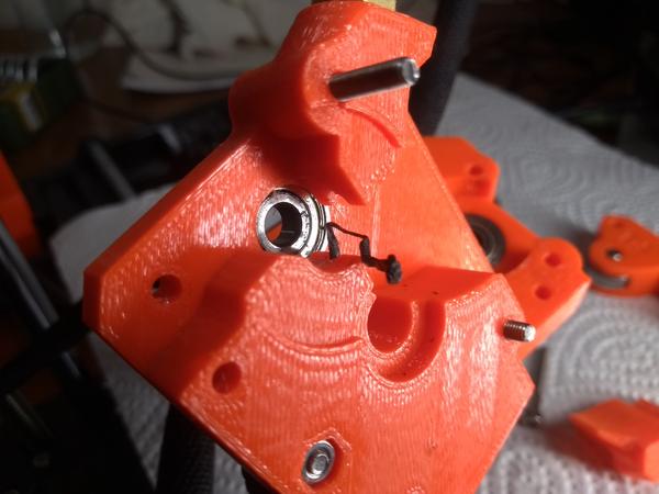 The Prusa Mini extruder, opened; a piece of filament stuck in there