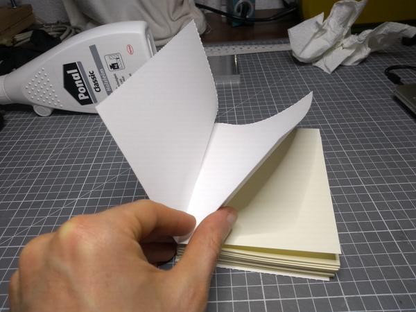 The text block for notebook #5, the doubled-up end pages being held up by a hand.